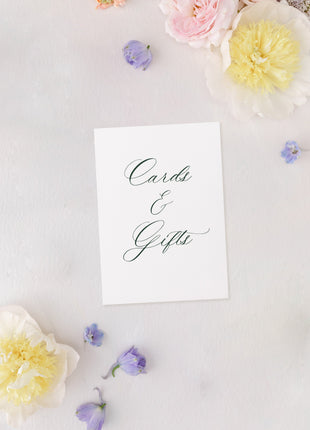 White card with 'Cards & Gifts' text surrounded by pastel flowers on a light background